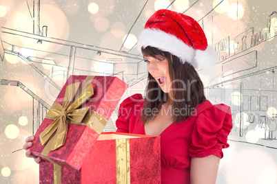 Composite image of surprised festive brunette holding a gift