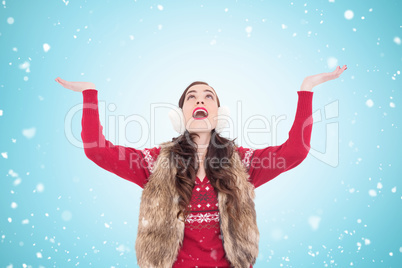 Composite image of brunette in winter clothes with hands out