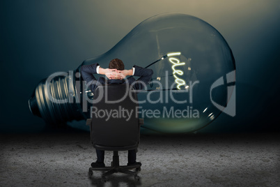 Composite image of businessman sitting in swivel chair