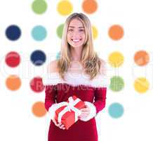 Composite image of pretty santa girl holding gift