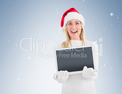 Festive blonde showing a laptop