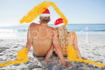 Composite image of rear view of couple sitting on beach