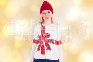 Composite image of festive blonde in christmas jumper