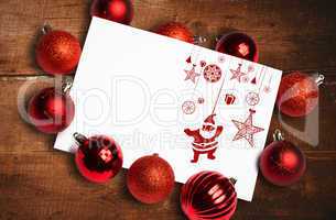 Composite image of hanging red christmas decorations