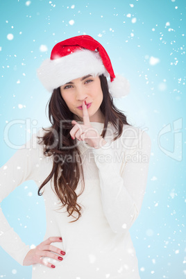 Composite image of festive brunette in santa hat keeping a secre