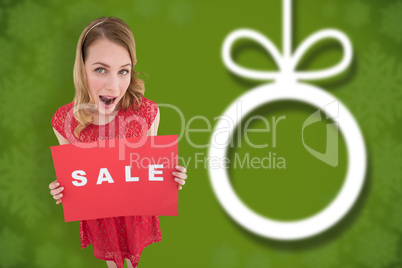 Composite image of surprised blonde showing a red sale poster