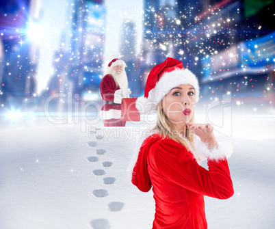 Composite image of festive blonde blowing a kiss