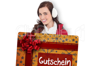 Composite image of beautiful brunette showing gift card