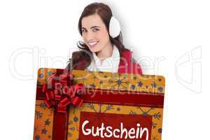 Composite image of beautiful brunette showing gift card