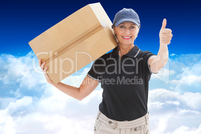 Composite image of happy delivery woman holding cardboard box