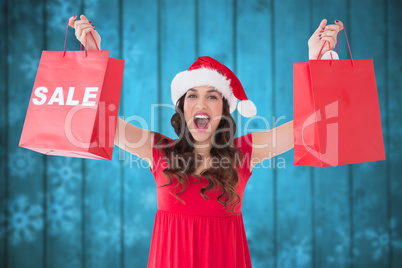 Composite image of brunette showing sale bag and shopping bag