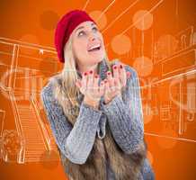 Composite image of blonde in winter clothes with hands out