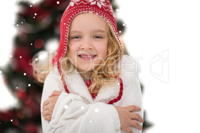 Composite image of festive little girl in hat and scarf