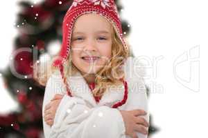 Composite image of festive little girl in hat and scarf