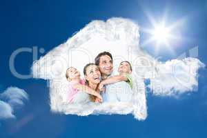 Composite image of happy young family looking up together