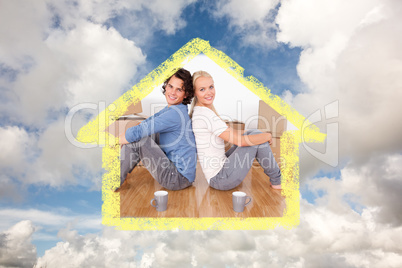 Composite image of couple sitting on the floor