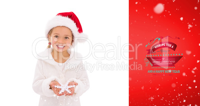 Composite image of festive little girl holding snowflake