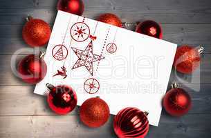 Composite image of hanging red christmas decorations