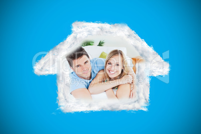 Composite image of smiling beatiful couple sitting on a sofa