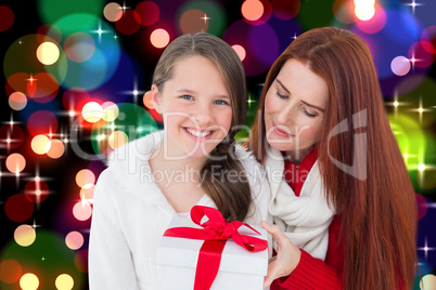 Composite image of mother and daughter with gift