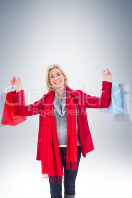 Blonde in winter clothes holding shopping bags