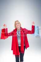 Blonde in winter clothes holding shopping bags