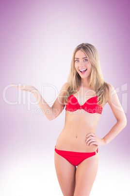 Fit blonde in red bikini showing scales