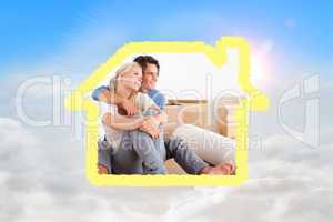 Composite image of smiling couple sitting on the floor