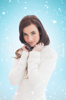 Composite image of brunette in white jumper smiling at camera