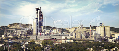 panorama of a cement plant in a sunny summer afternoon