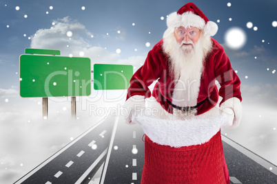 Composite image of santa open his red bag