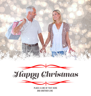 Composite image of happy couple with shopping bags