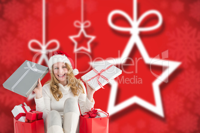 Composite image of happy woman sitting on the floor while holdin