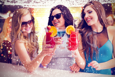 Composite image of friends drinking cocktails