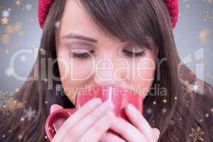 Composite image of close up of a festive brunette drinking from