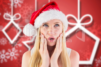Composite image of festive blonde looking surprised with hands o
