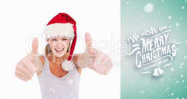 Composite image of woman with the thumbs up and a christmas hat
