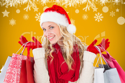 Composite image of happy festive blonde with shopping bags