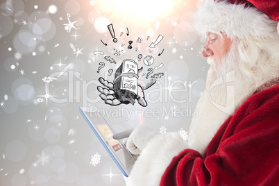 Composite image of santa uses a tablet pc