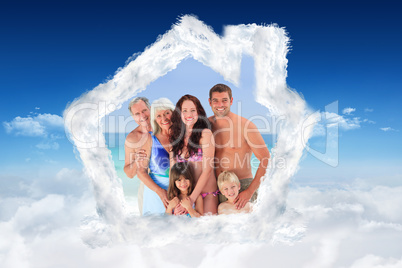Composite image of portrait of a joyful family at the beach