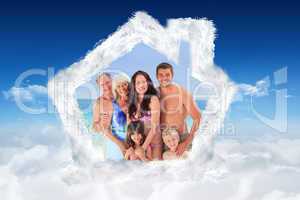 Composite image of portrait of a joyful family at the beach