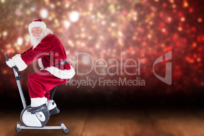 Composite image of santa uses a home trainer