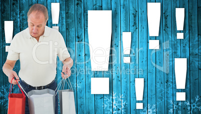 Composite image of man looking in shopping bags