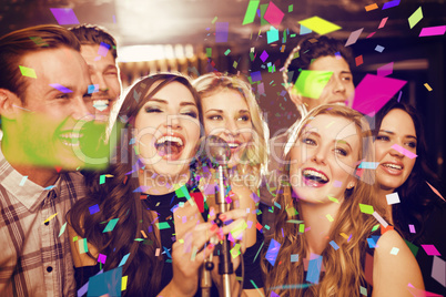 Composite image of happy friends singing karaoke together