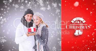 Composite image of happy winter couple with gift