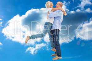 Composite image of mature couple hugging and having fun