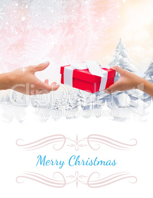 Composite image of couple passing a wrapped gift