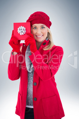Festive blonde holding red gift