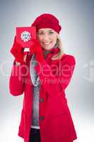 Festive blonde holding red gift