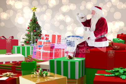 Composite image of santa delivering gifts from cart